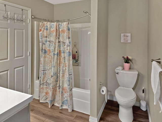 1409 Hull St, Normal, IL 61761 - bathroom featuring shower / tub combo, wood finished floors, toilet, vanity, and baseboards