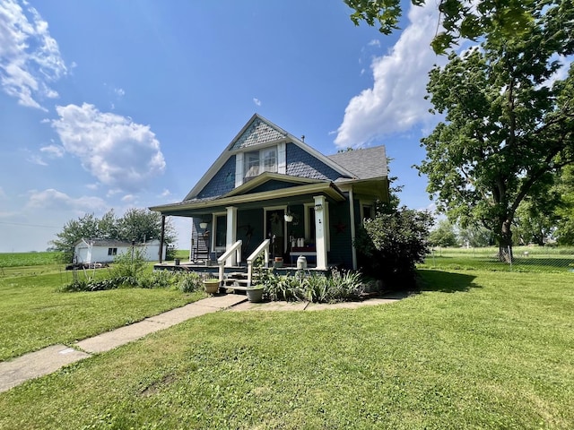 207 W 2nd St, Broadlands, IL 61816 - view of front of property featuring a porch and a front lawn