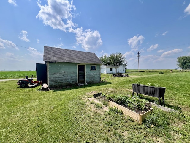 207 W 2nd St, Broadlands, IL 61816 - view of grassy yard featuring a garden and an outbuilding