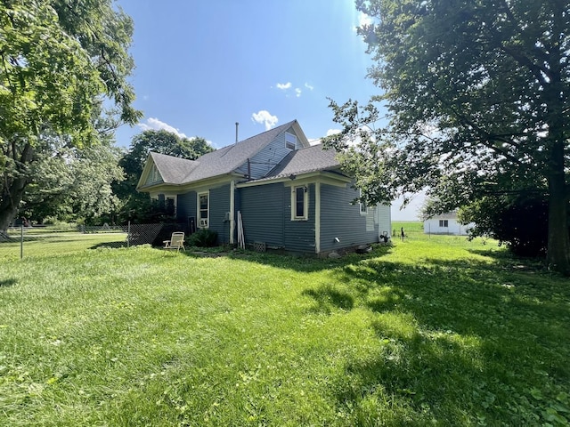 207 W 2nd St, Broadlands, IL 61816 - view of side of home with a lawn and roof with shingles