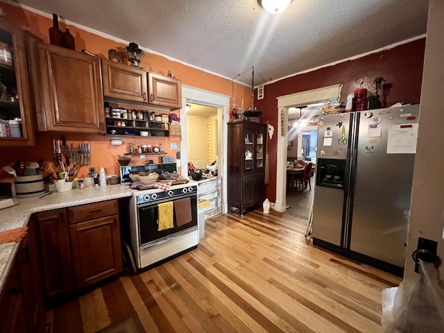 207 W 2nd St, Broadlands, IL 61816 - kitchen with white range, stainless steel fridge, a textured ceiling, light wood finished floors, and open shelves