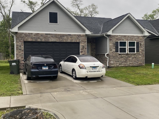 3636 W 139th Pl Unit 0, Robbins, IL 60472 - view of front facade featuring stone siding, driveway, a shingled roof, a front yard, and an attached garage