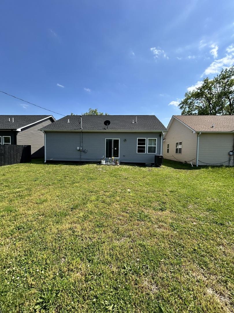 3636 W 139th Pl Unit 0, Robbins, IL 60472 - back of property with a lawn and central AC unit