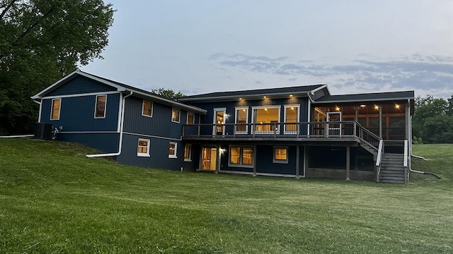 15501 Bishop Rd, Morrison, IL 61270 - back of property featuring a yard, a sunroom, and a deck