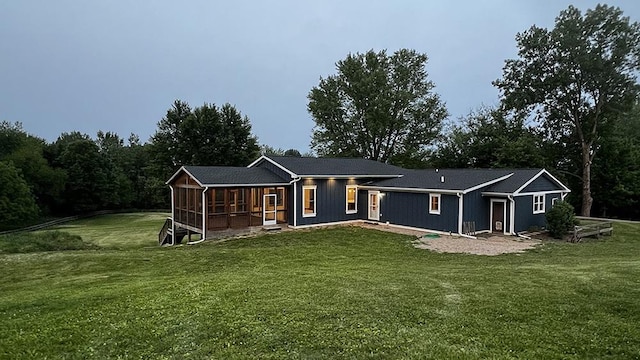 15501 Bishop Rd, Morrison, IL 61270 - rear view of property featuring a sunroom and a yard