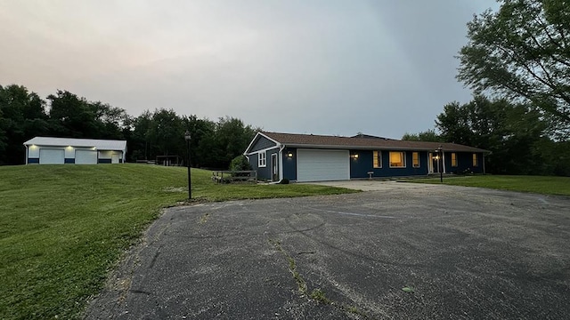 15501 Bishop Rd, Morrison, IL 61270 - single story home with asphalt driveway, a front lawn, and an attached garage