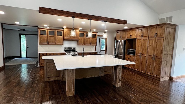 15501 Bishop Rd, Morrison, IL 61270 - kitchen featuring appliances with stainless steel finishes, a sink, brown cabinetry, a large island with sink, and dark wood finished floors