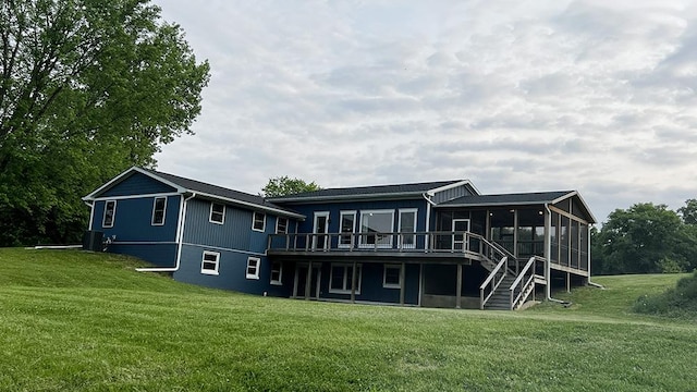 15501 Bishop Rd, Morrison, IL 61270 - back of property with a sunroom, a yard, a wooden deck, and central AC