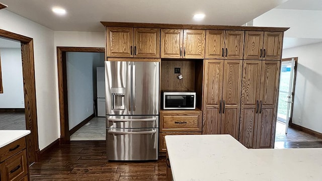 15501 Bishop Rd, Morrison, IL 61270 - kitchen with appliances with stainless steel finishes, baseboards, dark wood-style flooring, recessed lighting, and brown cabinetry