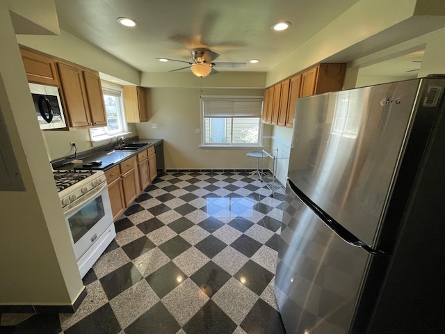 11 Shagbark Rd, Lake Bluff, IL 60044 - kitchen with freestanding refrigerator, white gas range, dark countertops, recessed lighting, and a sink