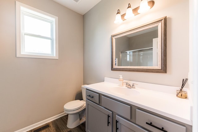 492 S Hampstead St, Cortland, IL 60112 - full bath with vanity, wood finished floors, toilet, baseboards, and an enclosed shower