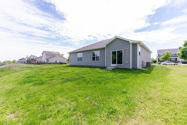 492 S Hampstead St, Cortland, IL 60112 - back of house with central AC unit, entry steps, and a yard