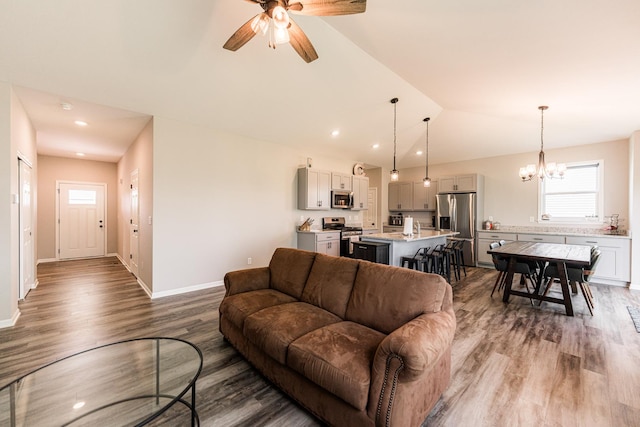 492 S Hampstead St, Cortland, IL 60112 - living area featuring wood finished floors, a chandelier, lofted ceiling, ceiling fan, and baseboards