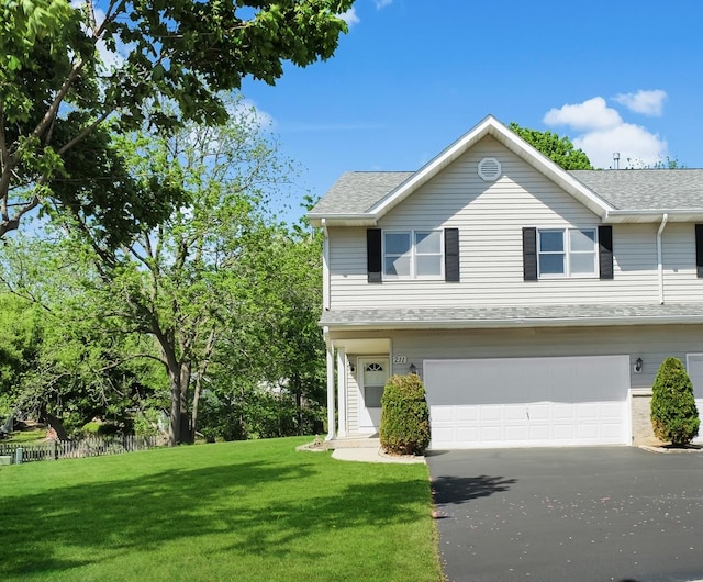 211 Lorien Ct, East Dundee, IL 60118 - view of front of home with an attached garage, a front yard, driveway, and a shingled roof