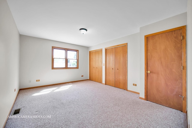 211 Lorien Ct, East Dundee, IL 60118 - unfurnished bedroom featuring multiple closets, carpet, and baseboards
