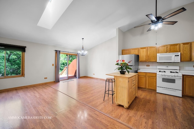 211 Lorien Ct, East Dundee, IL 60118 - kitchen featuring white appliances, a chandelier, wood finished floors, ceiling fan, and high vaulted ceiling