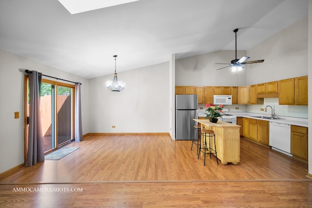 211 Lorien Ct, East Dundee, IL 60118 - kitchen with white appliances, a sink, a chandelier, light wood-type flooring, and a center island