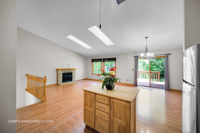 211 Lorien Ct, East Dundee, IL 60118 - kitchen featuring freestanding refrigerator, light wood finished floors, lofted ceiling, and healthy amount of natural light