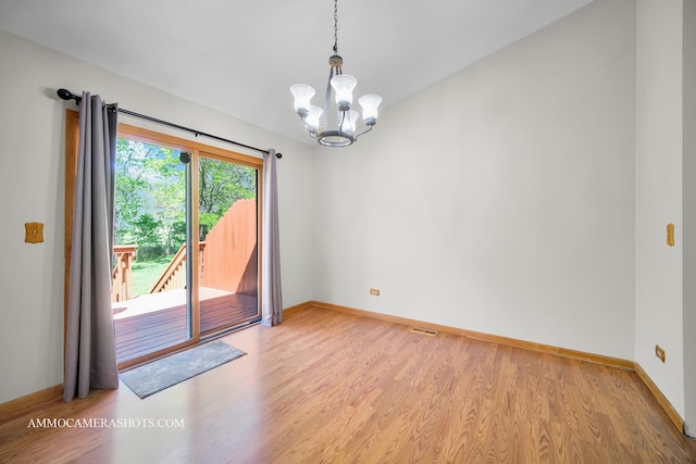 211 Lorien Ct, East Dundee, IL 60118 - spare room with wood finished floors, a chandelier, and baseboards