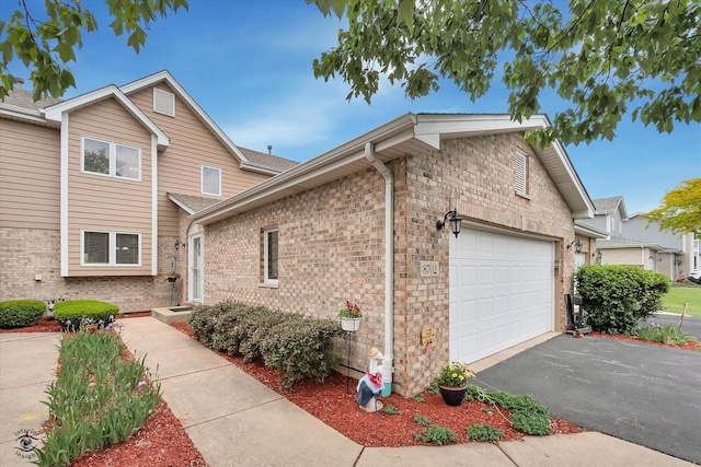 8702 Bally Castle Ln, Tinley Park, IL 60487 - view of front of property with an attached garage, brick siding, and driveway