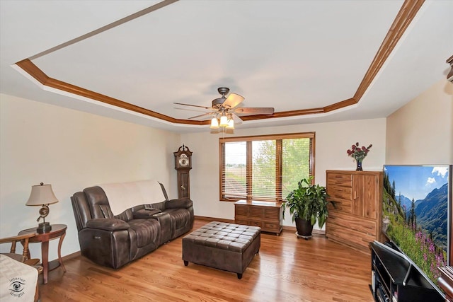 8702 Bally Castle Ln, Tinley Park, IL 60487 - living area featuring a tray ceiling, baseboards, ceiling fan, light wood-style floors, and ornamental molding