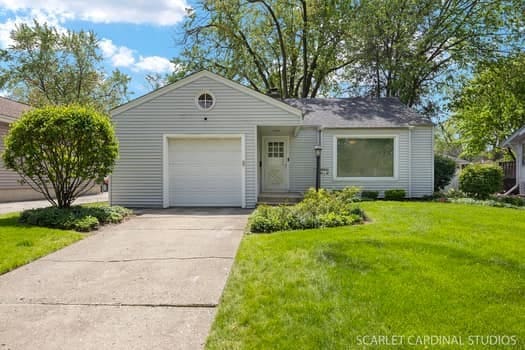 275 E Division St, Villa Park, IL 60181 - view of front of property with concrete driveway, a front yard, and a garage