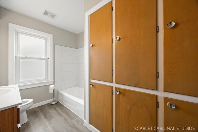 275 E Division St, Villa Park, IL 60181 - bathroom with wood finished floors, toilet, vanity, baseboards, and bathtub / shower combination
