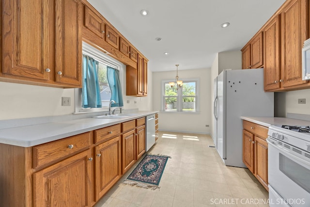 275 E Division St, Villa Park, IL 60181 - kitchen featuring white appliances, a sink, brown cabinets, a chandelier, and light countertops