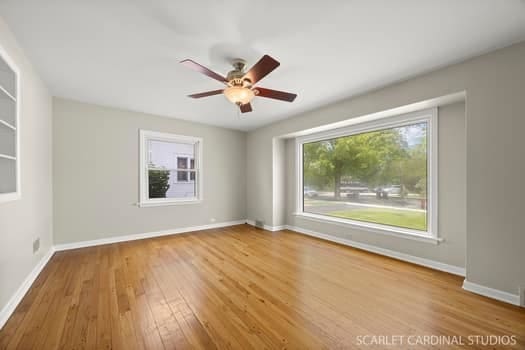 275 E Division St, Villa Park, IL 60181 - empty room with wood finished floors, a ceiling fan, and baseboards