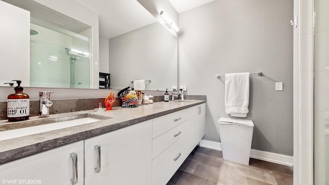 1203 W Superior St Unit 1C, Chicago, IL 60642 - full bathroom featuring a stall shower, baseboards, toilet, double vanity, and wood finished floors
