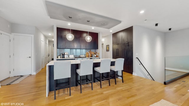 1203 W Superior St Unit 1C, Chicago, IL 60642 - kitchen with modern cabinets, light wood finished floors, light countertops, dark brown cabinets, and recessed lighting