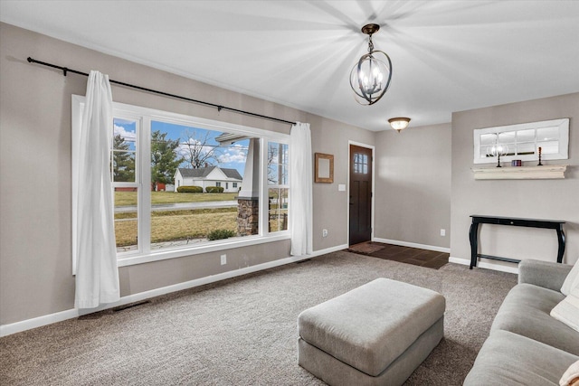 2225 County Road 1700 N, Saint Joseph, IL 61873 - living area featuring carpet floors, a chandelier, and baseboards
