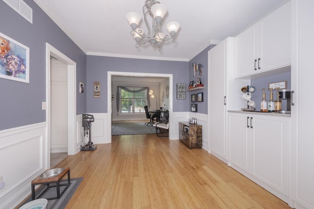 1710 Fraser Dr, Normal, IL 61761 - bar area featuring a chandelier, light wood-style flooring, wainscoting, and ornamental molding