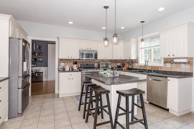 1710 Fraser Dr, Normal, IL 61761 - kitchen featuring appliances with stainless steel finishes, dark countertops, a sink, and recessed lighting