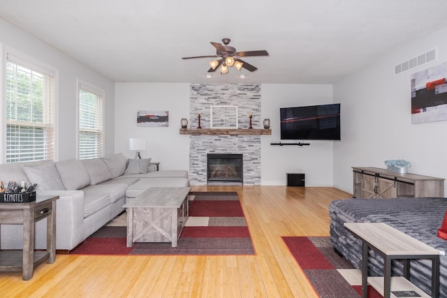 1710 Fraser Dr, Normal, IL 61761 - living area featuring wood finished floors, ceiling fan, and a fireplace