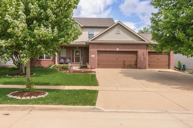 1710 Fraser Dr, Normal, IL 61761 - view of front of home with a garage, driveway, a front yard, brick siding, and roof with shingles