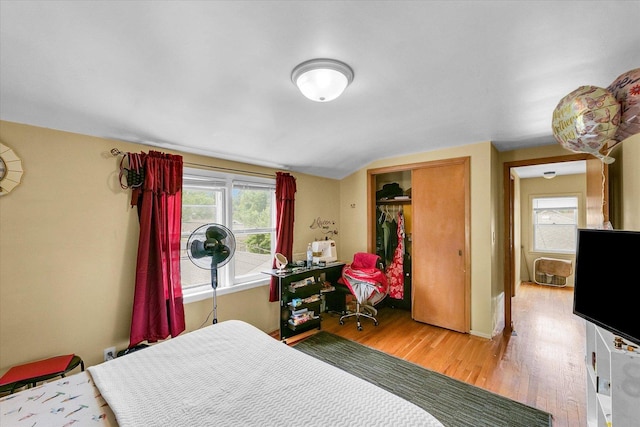 1117 W Springfield Ave, Champaign, IL 61821 - bedroom with wood finished floors, a closet, lofted ceiling, and baseboards