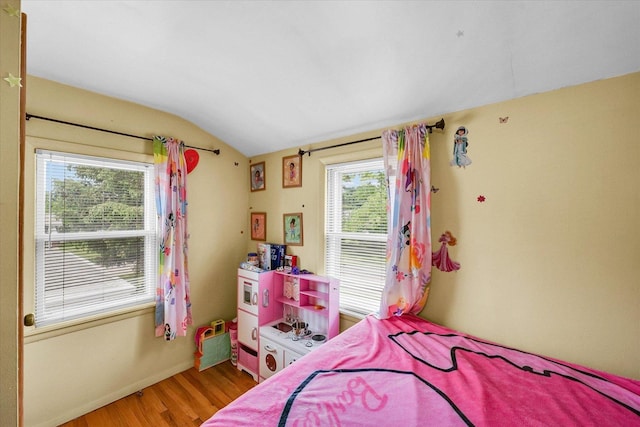 1117 W Springfield Ave, Champaign, IL 61821 - bedroom with lofted ceiling, wood finished floors, and baseboards