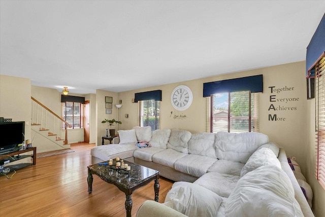 1117 W Springfield Ave, Champaign, IL 61821 - living room featuring light wood-style flooring and stairway