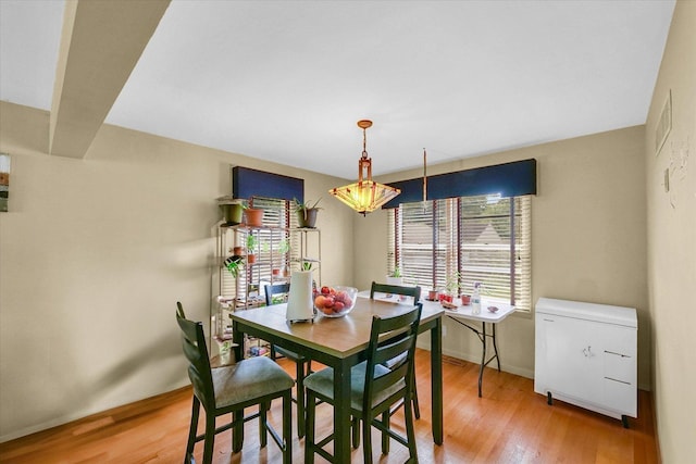 1117 W Springfield Ave, Champaign, IL 61821 - dining room featuring light wood-type flooring, baseboards, and a chandelier