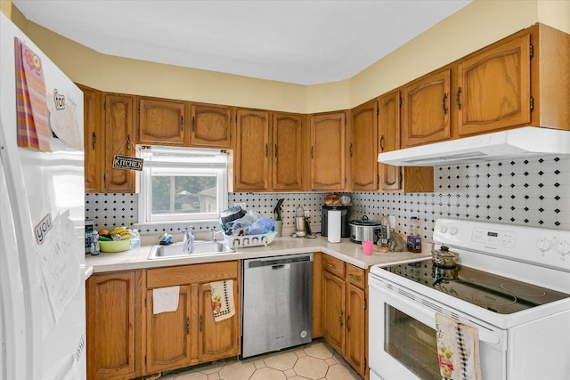 1117 W Springfield Ave, Champaign, IL 61821 - kitchen with white appliances, under cabinet range hood, a sink, and brown cabinets
