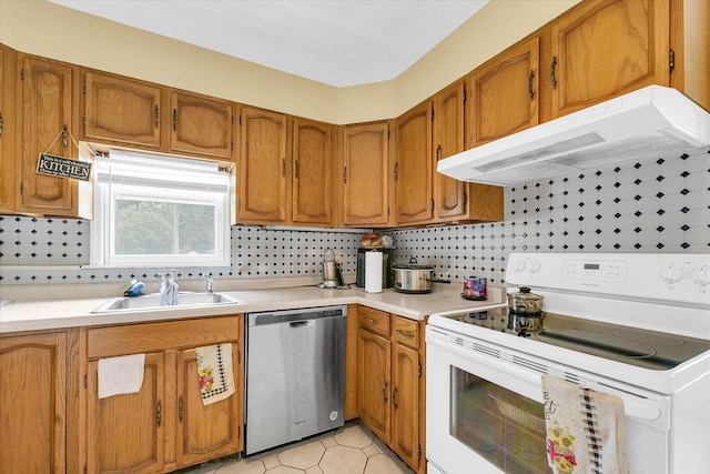 1117 W Springfield Ave, Champaign, IL 61821 - kitchen with electric range, stainless steel dishwasher, under cabinet range hood, a sink, and brown cabinetry
