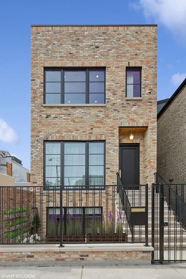 2014 N Winchester Ave, Chicago, IL 60614 - modern home featuring a fenced front yard, brick siding, and stairs