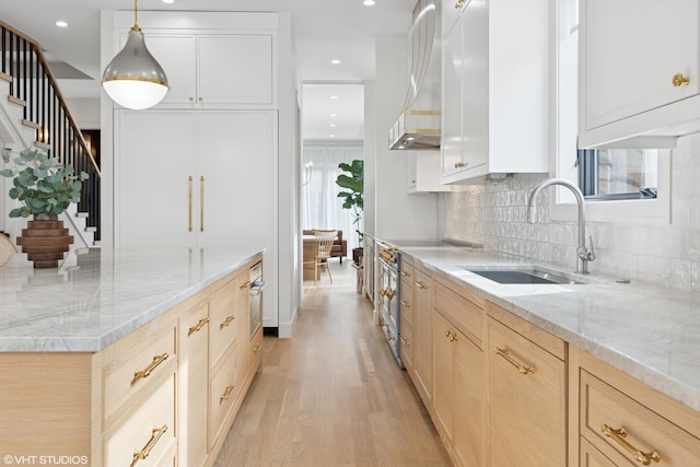 2014 N Winchester Ave, Chicago, IL 60614 - kitchen featuring a sink, light wood-style floors, light brown cabinetry, wall chimney range hood, and tasteful backsplash