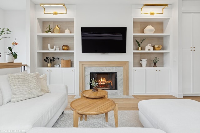 2014 N Winchester Ave, Chicago, IL 60614 - living room with a high end fireplace, built in shelves, and light wood-type flooring