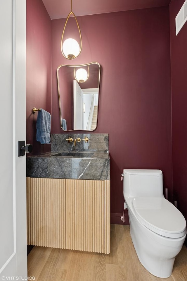 2014 N Winchester Ave, Chicago, IL 60614 - half bath featuring toilet, vanity, baseboards, and wood finished floors