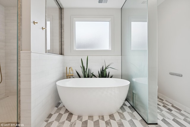 2014 N Winchester Ave, Chicago, IL 60614 - bathroom with a soaking tub, tile walls, tile patterned floors, and tiled shower