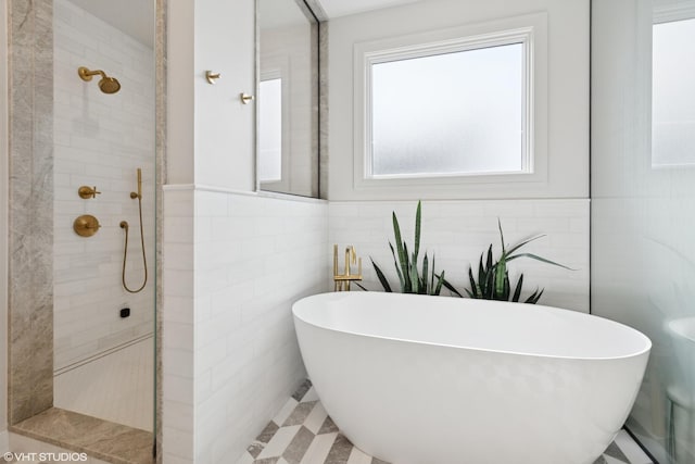 2014 N Winchester Ave, Chicago, IL 60614 - full bathroom with tiled shower, a freestanding tub, tile walls, and a wainscoted wall