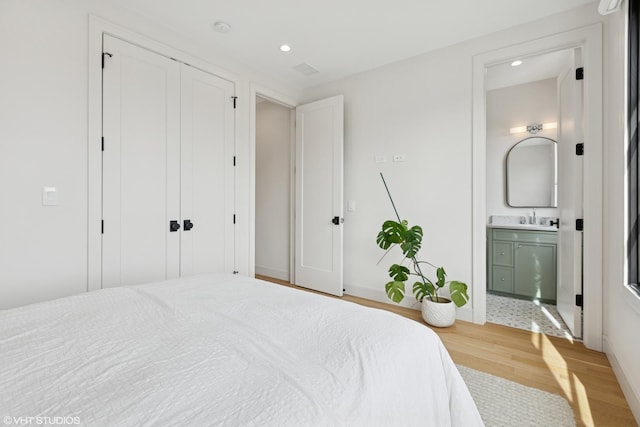2014 N Winchester Ave, Chicago, IL 60614 - bedroom featuring light wood-style floors, a sink, recessed lighting, baseboards, and connected bathroom