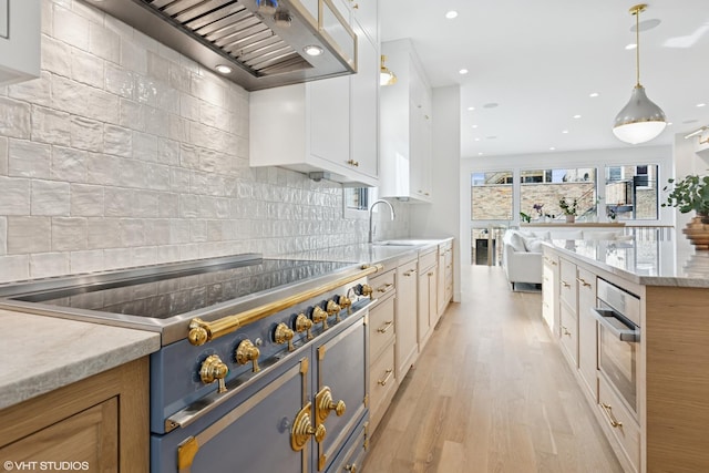 2014 N Winchester Ave, Chicago, IL 60614 - kitchen with stove, wall chimney exhaust hood, decorative backsplash, open floor plan, and recessed lighting